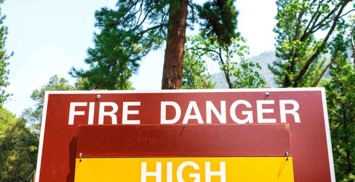 A wildfire season status sign that reads "FIRE DANGER HIGH".